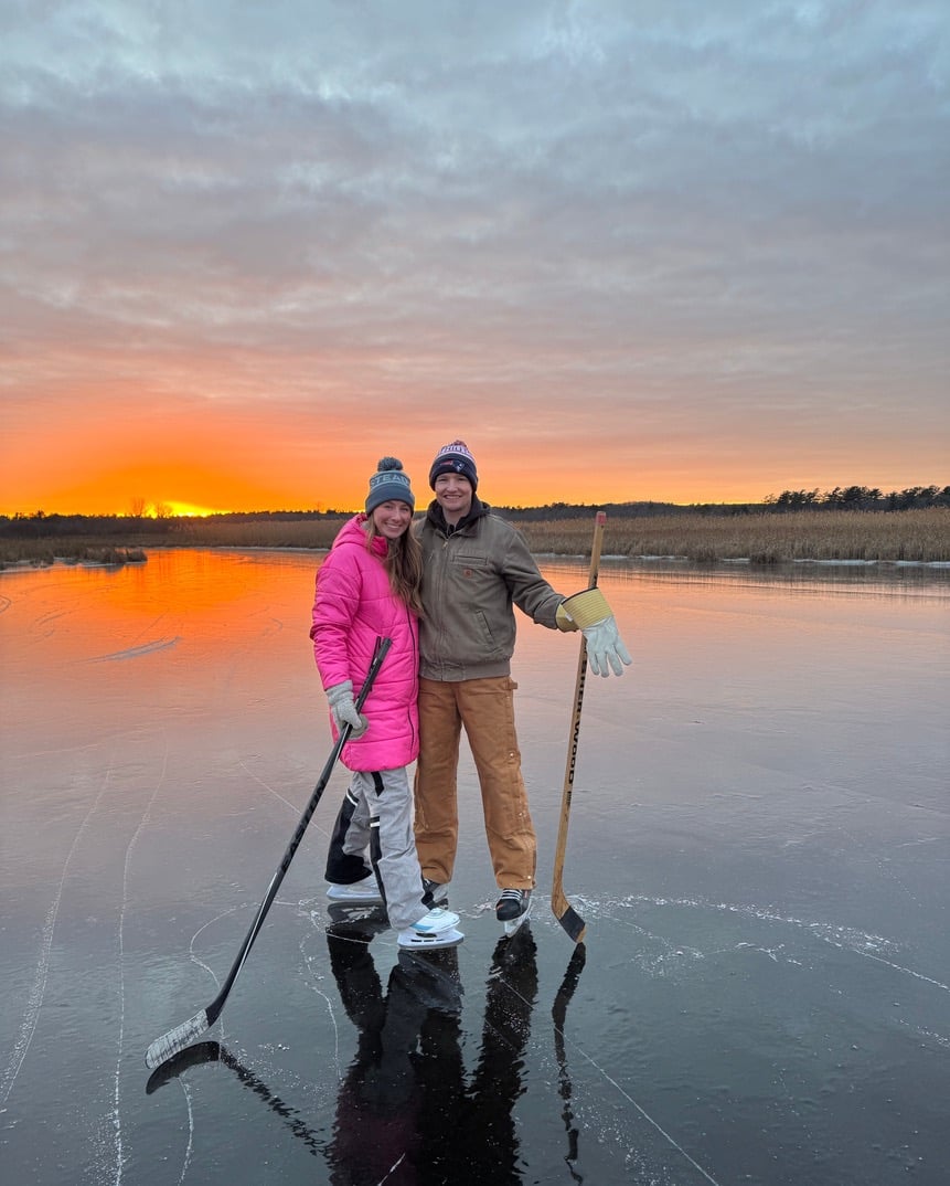Grace Slattery ice skating on a lake with her husband.